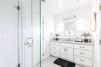 a white bathroom with a sink and a shower at Venice 2BR - Ocean Walk with Stunning Outdoor Space! in Los Angeles
