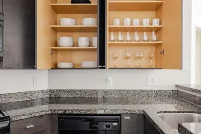 a kitchen with wooden cabinets and white dishes at Blueground Venice pool AC nr beach LAX-1330 in Los Angeles