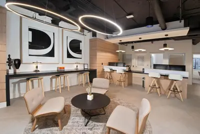 a room with a table and chairs and a kitchen at Blueground Venice pool AC nr beach LAX-1330 in Los Angeles