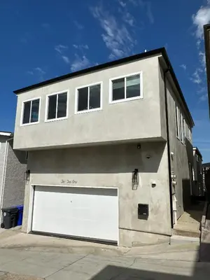 a building with a large white garage door at MB Modern Sand Section Sea View in Manhattan Beach