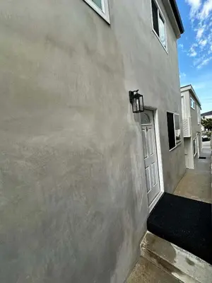 a side of a house with a concrete wall at MB Modern Sand Section Sea View in Manhattan Beach