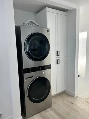 two washing machines stacked on top of each other in a room at MB Modern Sand Section Sea View in Manhattan Beach