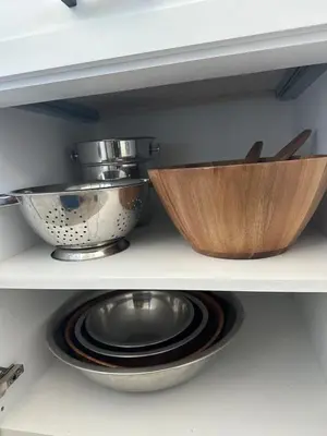 a shelf with two bowls and a pot on it at Manhattan Beach Modern Panoramic Sea View in Manhattan Beach