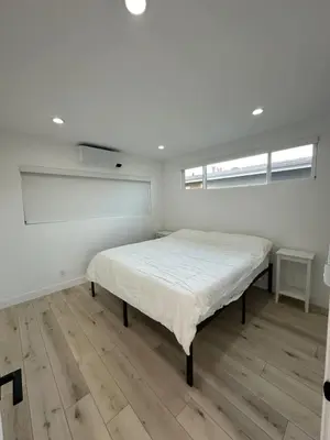 a bedroom with a bed in the middle of a room at Manhattan Beach Modern Panoramic Sea View in Manhattan Beach