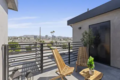 two chairs on the balcony of a house at Serene Hollywood in Los Angeles