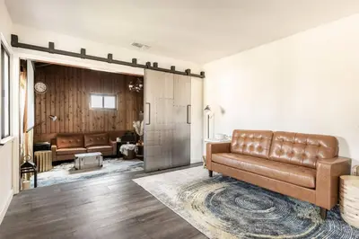 a living room with a brown leather couch in a room at Boy Travel in Hewitt
