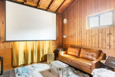 a living room with a couch and a large window at Boy Travel in Hewitt