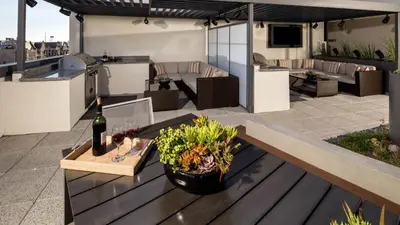 a patio with a table with a bottle of wine at Heart of Koreatwon, 1Bed Studio in Los Angeles