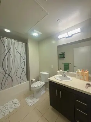 a bathroom with a toilet and a sink and a mirror at Heart of Koreatwon, 1Bed Studio in Los Angeles