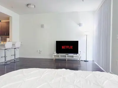 a white room with a bed and a tv at Heart of Koreatwon, 1Bed Studio in Los Angeles