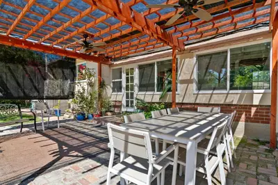 a table and chairs on a patio with a pergola at 4bed 3bath spacious modern piano home near Universal Studio and Hollywood for 10 in Studio City