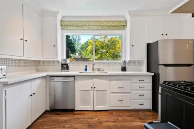 a kitchen with white cabinets and a window at 4bed 3bath spacious modern piano home near Universal Studio and Hollywood for 10 in Studio City