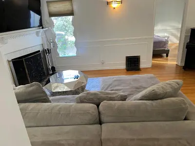 a living room with a couch and a fireplace at 4bed 3bath spacious modern piano home near Universal Studio and Hollywood for 10 in Studio City