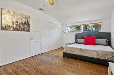 a bedroom with a bed with a red pillow on it at 4bed 3bath spacious modern piano home near Universal Studio and Hollywood for 10 in Studio City