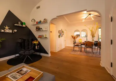 a living room and dining room with a table and chairs at Hauser House, Modern Artful Spanish-style Bungalow in Los Angeles