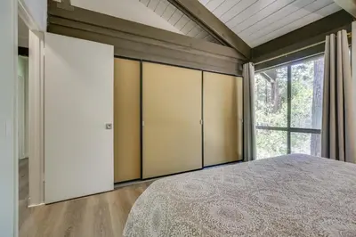 a bedroom with a bed and a large window at Ski, Hike and Explore! Twin Peaks Cabin with Deck in Twin Peaks
