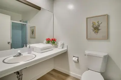 a bathroom with a sink and a toilet and a mirror at Ski, Hike and Explore! Twin Peaks Cabin with Deck in Twin Peaks