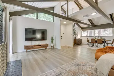 an open living room with white walls and a large flat screen tv at Ski, Hike and Explore! Twin Peaks Cabin with Deck in Twin Peaks