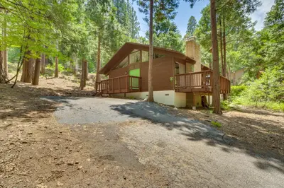 a house in the woods with a driveway at Ski, Hike and Explore! Twin Peaks Cabin with Deck in Twin Peaks