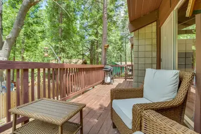 a porch with a wicker chair and a table at Ski, Hike and Explore! Twin Peaks Cabin with Deck in Twin Peaks