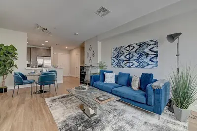 a living room with a blue couch and a table at Sexy One Bedroom Apartment - Pool View & Parking in Los Angeles