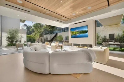 a living room with a white couch and a tv at Hutton Villa in Los Angeles