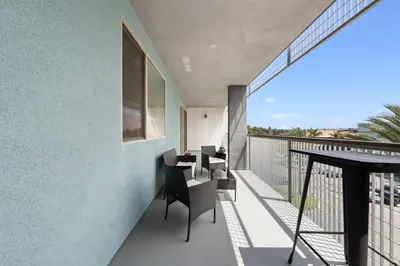 a balcony with a table and chairs on it at The Iris-Modern 3BD in the Heart of Marina del Rey-Pool,Gym,Jacuzzi-Near LAX in Los Angeles