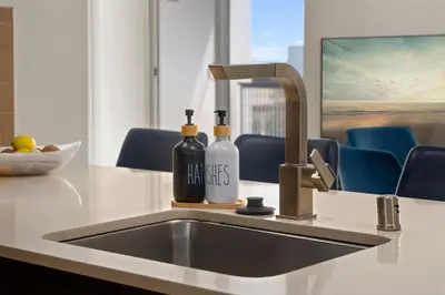 a kitchen sink with two bottles of wine at The Iris-Modern 3BD in the Heart of Marina del Rey-Pool,Gym,Jacuzzi-Near LAX in Los Angeles