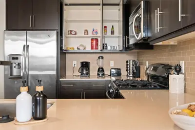 a kitchen with a stainless steel refrigerator at The Iris-Modern 3BD in the Heart of Marina del Rey-Pool,Gym,Jacuzzi-Near LAX in Los Angeles