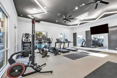 a gym with several tread machines and a flat screen tv at Deluxe Living in Marina Del Rey - Pool, Hot Tub, Gym in Los Angeles