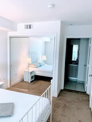 a bedroom with a bed and a mirror at Western and Santa Monica in Los Angeles