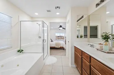 a white bathroom with a shower and a sink at Desert Family Oasis 4BR Near Trails Attractions in Palmdale
