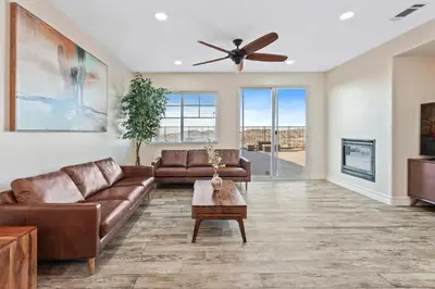 a living room with a couch and a ceiling fan at Desert Family Oasis 4BR Near Trails Attractions in Palmdale