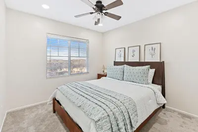 a bedroom with a bed and a ceiling fan at Desert Family Oasis 4BR Near Trails Attractions in Palmdale