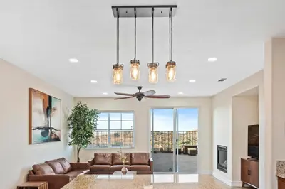 a living room with a couch and a ceiling fan at Desert Family Oasis 4BR Near Trails Attractions in Palmdale