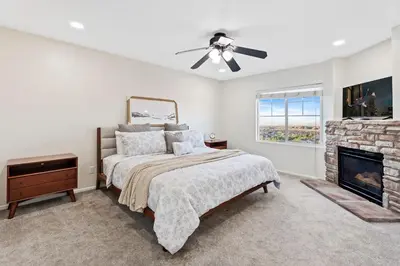 a bedroom with a bed and a fireplace at Desert Family Oasis 4BR Near Trails Attractions in Palmdale