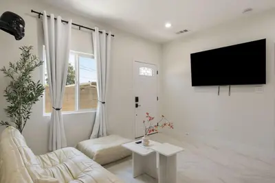 a white living room with a tv and a couch at Jedi Retreat-10mins to Disney-Hot Tub-Big Group in Anaheim