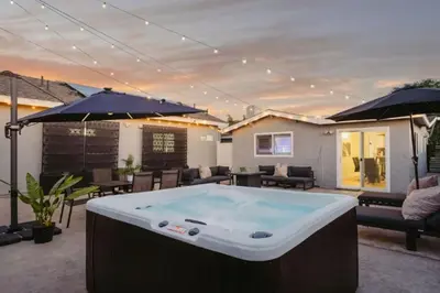 a pool table on a patio with umbrellas at Lightsaber Lounge-Hot Tub-Billiards-10mnstoDisney in Anaheim