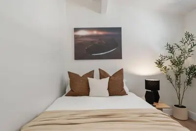 a bedroom with a large bed with brown pillows at Lightsaber Lounge-Hot Tub-Billiards-10mnstoDisney in Anaheim