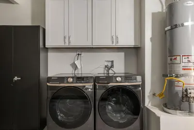 two washing machines in a kitchen with white cabinets at Lightsaber Lounge-Hot Tub-Billiards-10mnstoDisney in Anaheim