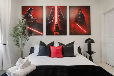 a bedroom with a bed with four posters on the wall at Darth Vaders Lair - 10 mins to Disney - Sleeps 6 in Anaheim