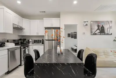 a kitchen with a table with chairs and a couch at Darth Vaders Lair - 10 mins to Disney - Sleeps 6 in Anaheim