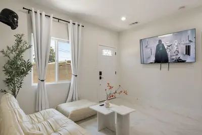 a living room with a couch and a tv on a wall at Darth Vaders Lair - 10 mins to Disney - Sleeps 6 in Anaheim