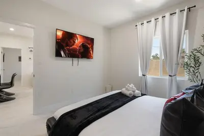 a bedroom with a bed with a picture on the wall at Darth Vaders Lair - 10 mins to Disney - Sleeps 6 in Anaheim