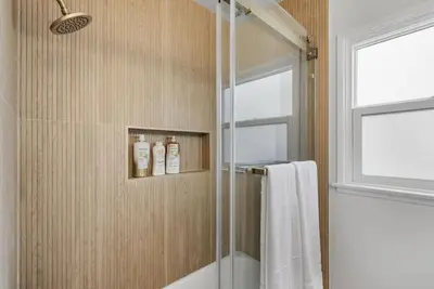 a bathroom with a shower with a glass door at Cascade Cove - Heated Pool Spa - Billiards and Lounge in Long Beach