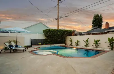 a swimming pool in the middle of a yard at Cascade Cove - Heated Pool Spa - Billiards and Lounge in Long Beach
