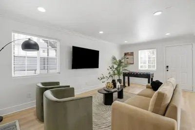 a living room with a couch and a table at Modern Elegance- Big Group - Games - Sleeps 10 in Los Angeles
