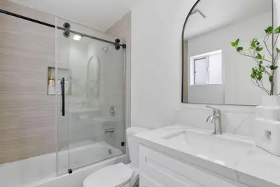 a white bathroom with a tub and a toilet and a sink at Modern Elegance- Big Group - Games - Sleeps 10 in Los Angeles