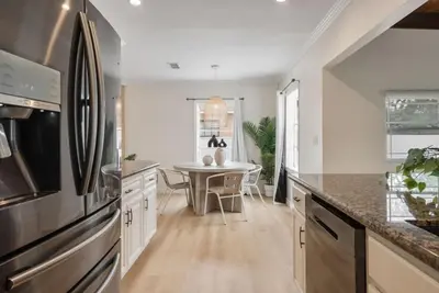 a kitchen with a table and a refrigerator at Stunning Retro Beach Oasis, Dual Living, Pool in Long Beach