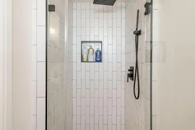 a bathroom with a shower with a bottle of soap at Designer Dream- Pool and spa- Game Room- Sleeps 10 in Los Angeles
